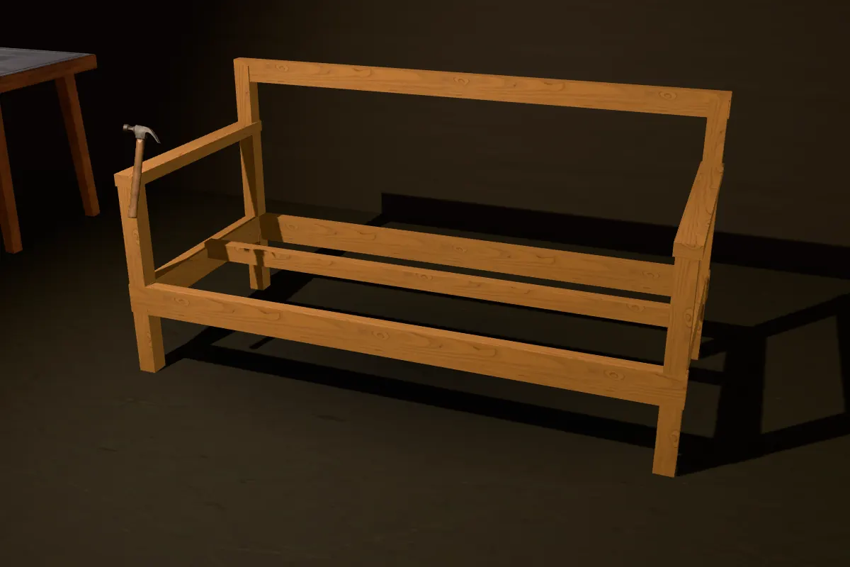 A sofa frame of raw teak planks, joined at the corners, with a hammer tapping a joint