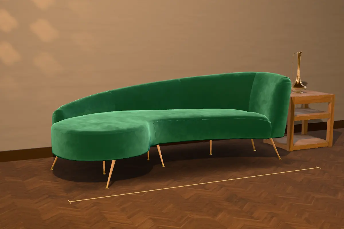 The Marina sofa in emerald velvet on teak legs, beside a small side table with a brass ewer
