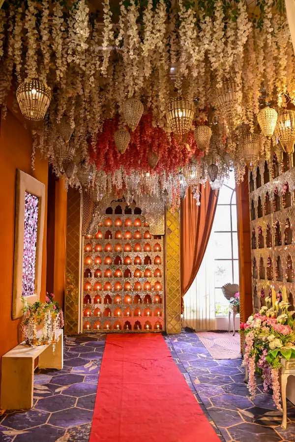 Hall entrance with a red carpet under hanging strings of white flowers