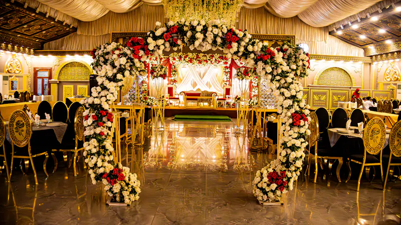 Flower arch at the hall entrance, with guest tables on both sides