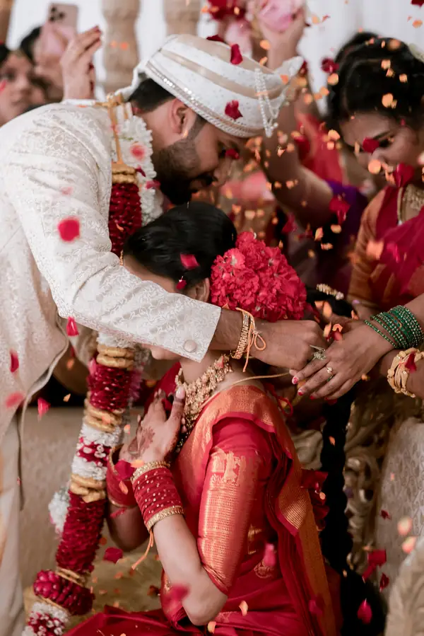 Family showering the couple with flower petals during the ceremony