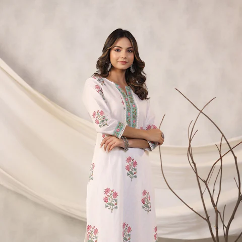 Woman in a white kurta set with pink floral print
