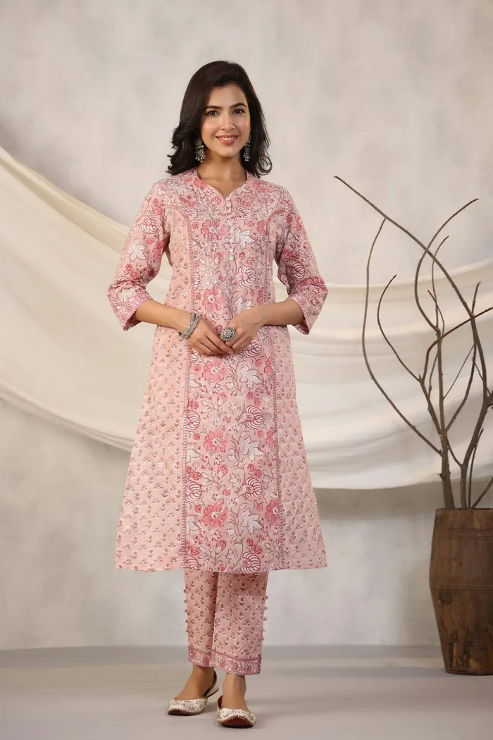 Woman in a pink floral printed kurta and trouser set